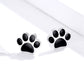 Sterling silver paw print stud earrings with black enamel paw pad design on each side