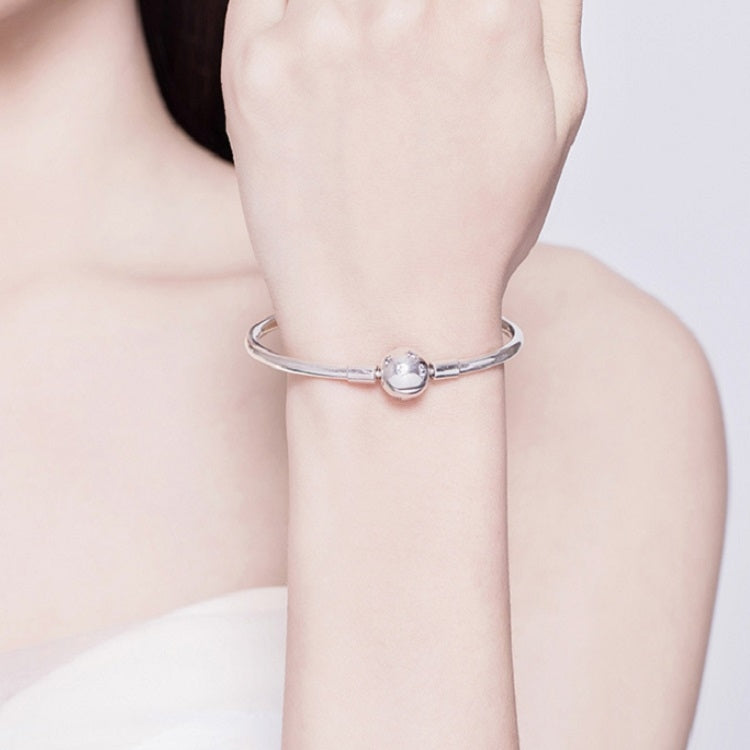 Sterling silver star bracelet worn on wrist with round star charm at center