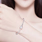 Sterling silver star bracelet on arm with small round star charm on cuff