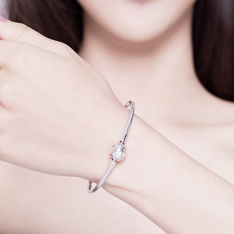 Sterling silver star bracelet on arm with small round star charm on cuff