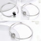 Sterling silver bangle bracelet with round paved bead centerpiece, shown at angles