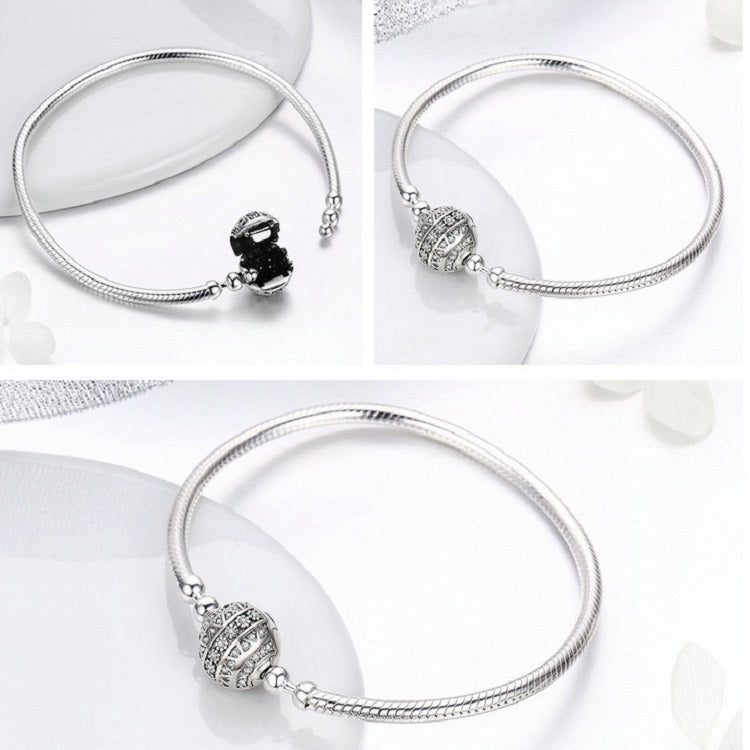 Sterling silver bangle bracelet with round paved bead centerpiece, shown at angles