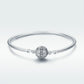 Sterling silver bangle bracelet with round paved centerpiece and small sphere connectors