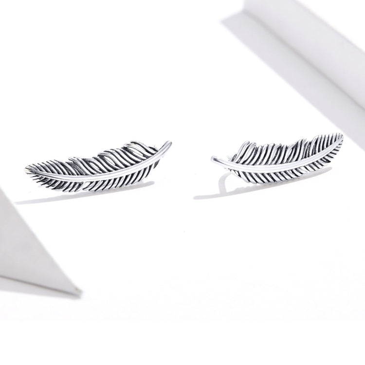 Sterling silver ribbed feather stud-style earrings, side view, pair
