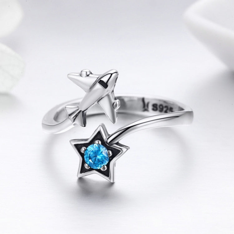 Silver open ring with stacked star charms and blue CZ center stone