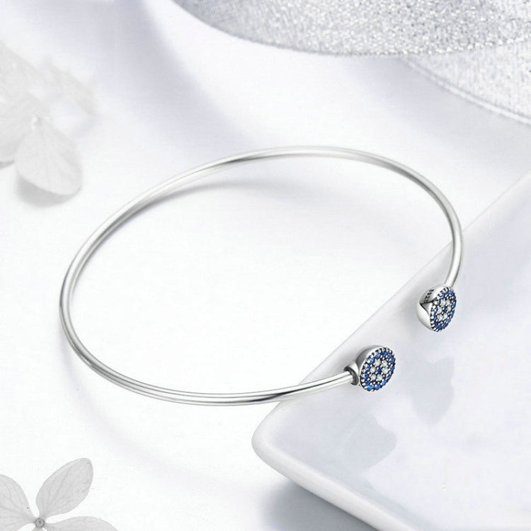 Sterling silver bangle bracelet with two round blue zircon inlaid discs on bar