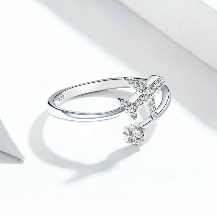 Open silver ring featuring airplane zircon motif with small round stones on top