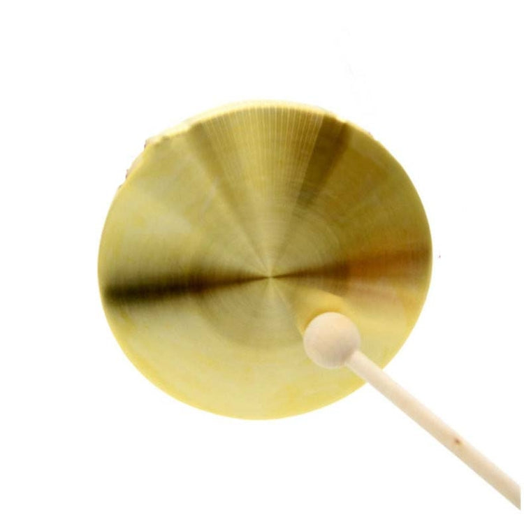 Gold brass gong close-up with mallet head