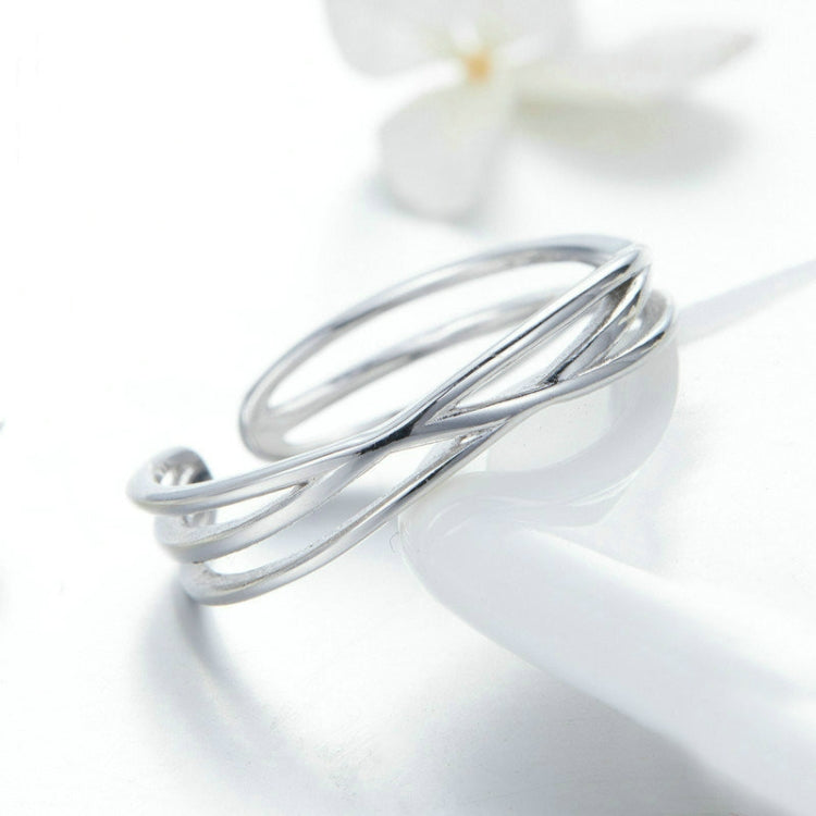 Silver open cuff-style ring with overlapping double bands and polished finish
