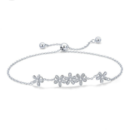 Sterling silver daisy charm bracelet with five flower motifs and adjustable chain
