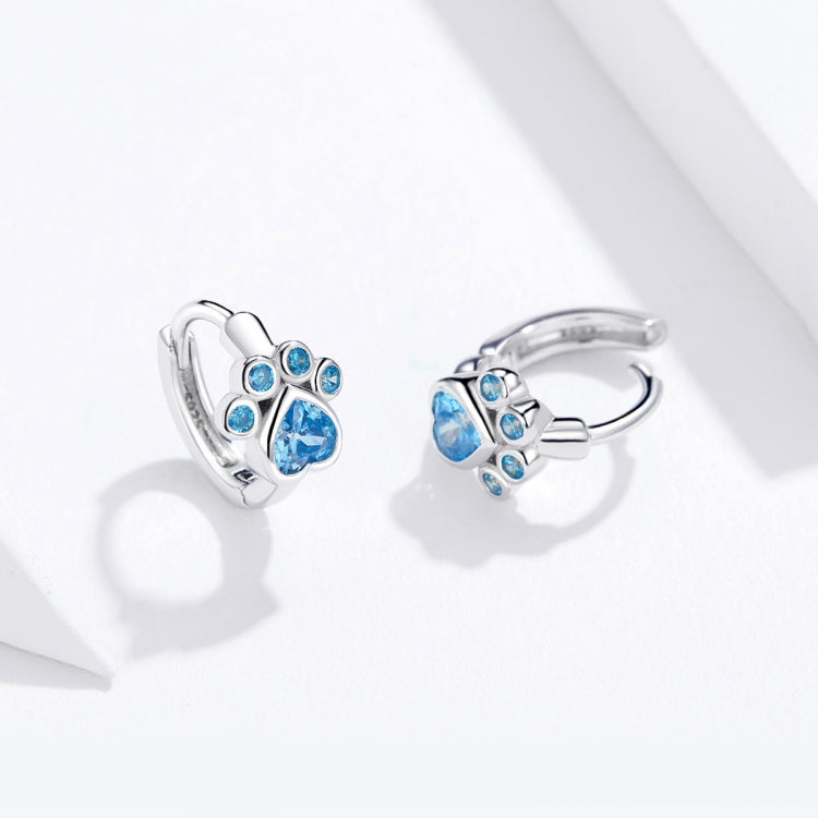 Sterling silver cat paw hoop earrings with blue stones and hinged clasp, front view
