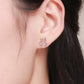 Sterling silver cat-heart earrings worn on ear, hollow cat outline over heart