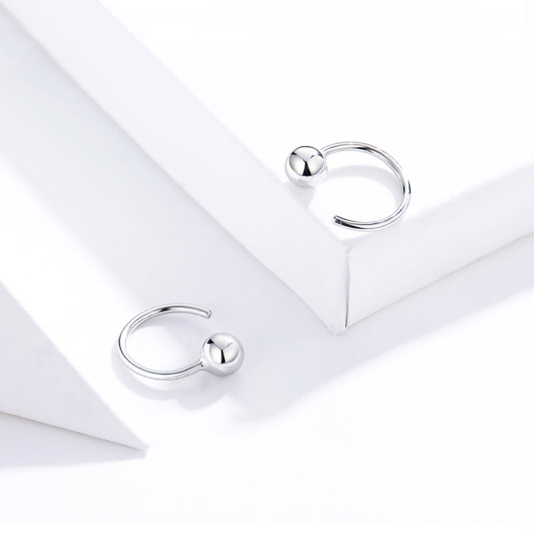 Small silver ball hoop earrings with round spheres and curved wire hoops