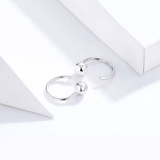 Pair of silver ball hoop earrings with small glossy spheres on the hoop wires
