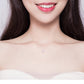 Round zircon pendant necklace on model’s neckline, sterling silver fine chain