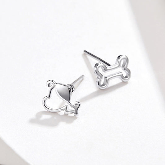 Sterling silver dog bone stud earrings with hollow outline, angled profile
