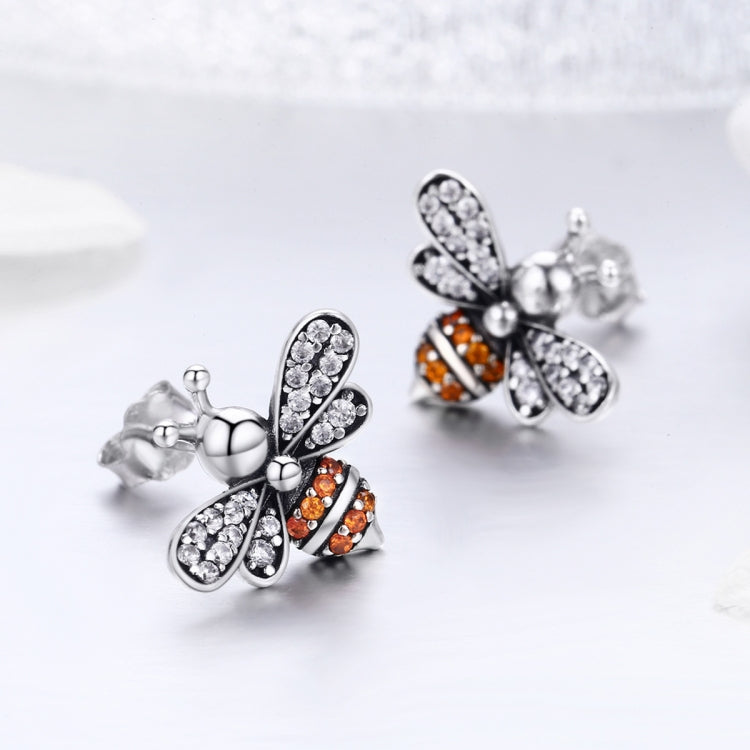 Bee stud earrings in sterling silver with clear and orange stone accents