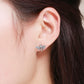 Bee stud earrings in sterling silver with white stones and a small gold accent.