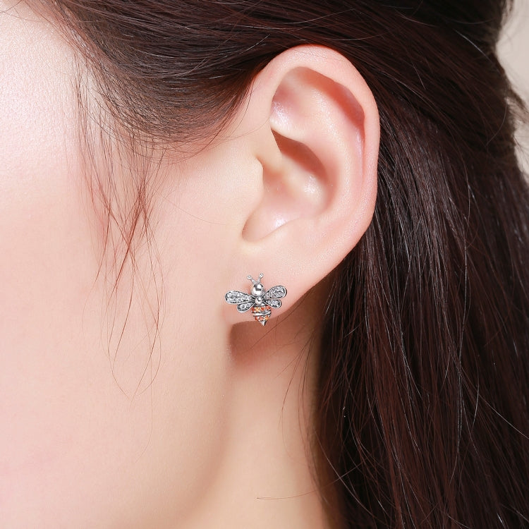 Bee stud earrings in sterling silver with white stones and a small gold accent.