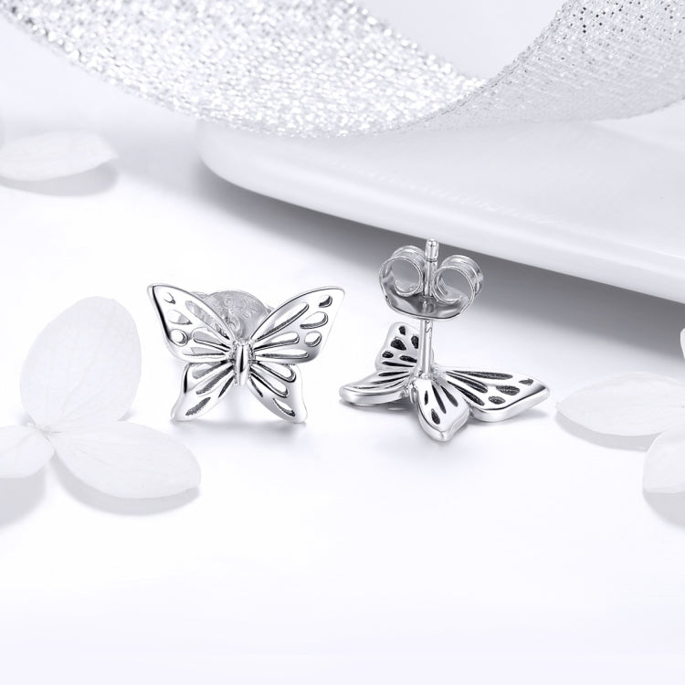 Sterling silver butterfly stud earrings with glossy wing outlines and central bow knot