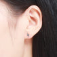 Sterling silver lightning bolt stud earring on model ear with black accents