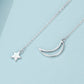 Silver-toned necklace with crescent moon and star charms on delicate chain