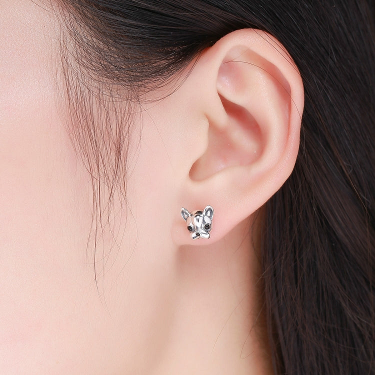 Bulldog stud earrings worn on ear, sterling silver with black enamel eyes