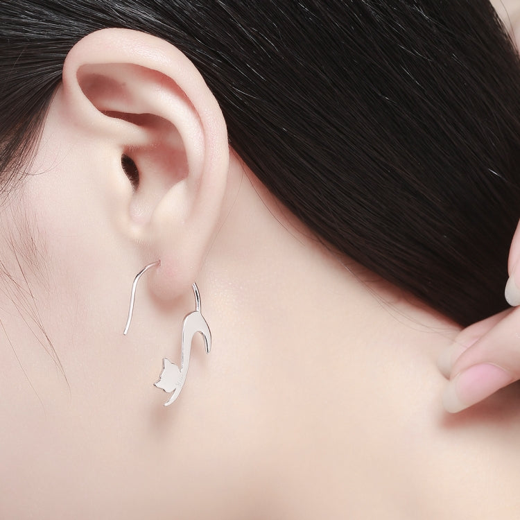 Cat drop earrings on ear, sterling silver outline with dangling cat silhouette