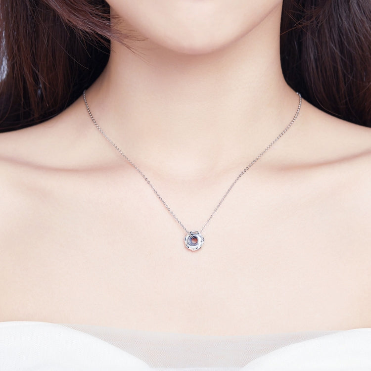 Sterling silver zircon pendant necklace with round centerpiece on a thin chain