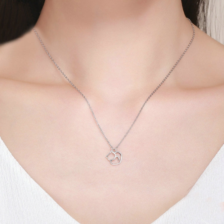 Sterling silver cat-and-heart pendant necklace on model, resting at collarbone