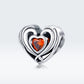 Heart-shaped sterling silver charm bead with orange heart CZ, ringed by nested hearts