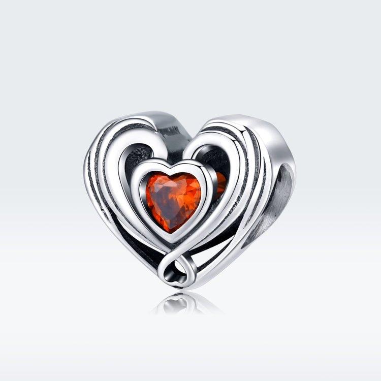Heart-shaped sterling silver charm bead with orange heart CZ, ringed by nested hearts