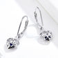 Sterling silver hollow heart drop earrings with blue accents