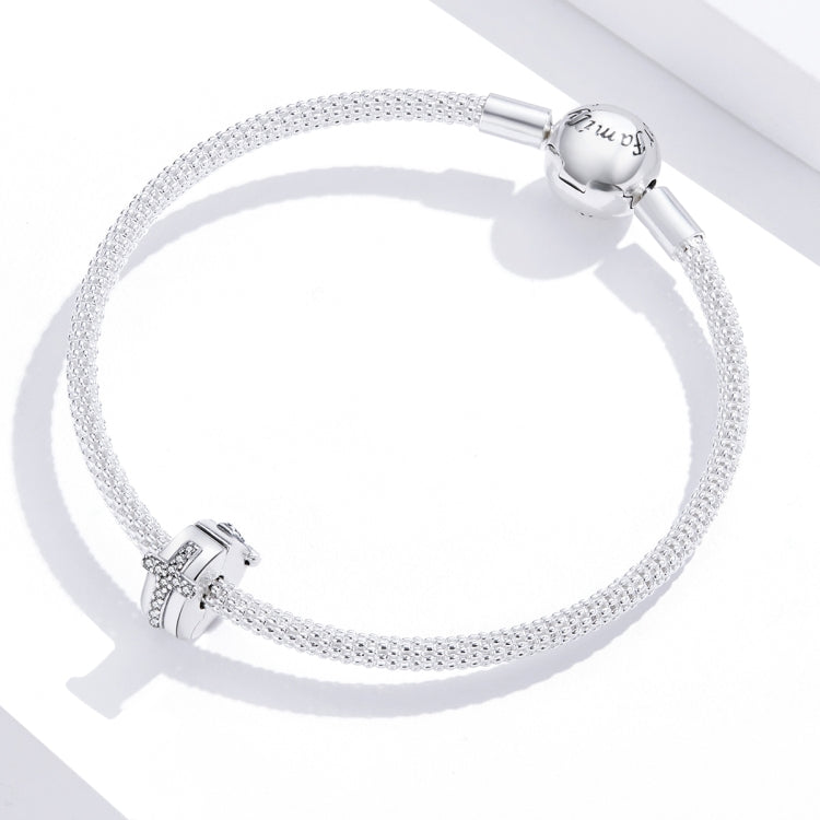 Sterling silver beaded bracelet with round charm and cross-shaped clasp