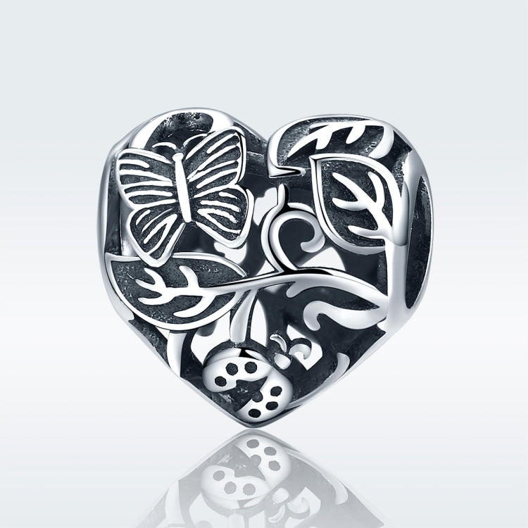 Sterling silver heart charm bead with butterfly, leaf, and flower engravings