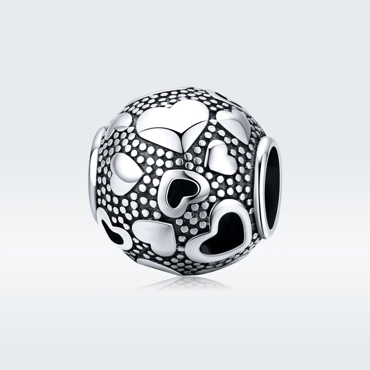 Round sterling silver charm bead with heart cutout pattern and black enamel accents