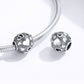 Pair of round sterling silver heart-pattern bead charms with black enamel on snake chain