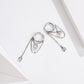 Two silver hoop zircon tassel earrings with round charm center and teardrop drops