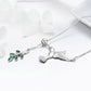 Sterling silver hummingbird necklace with green enamel leaf flower and CZ detail