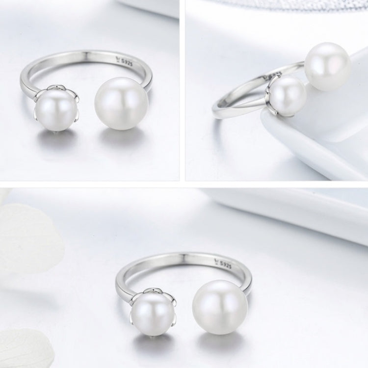 Sterling silver open ring with two round white pearl-style cabochons, side-by-side