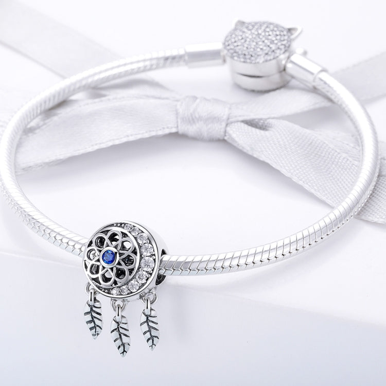 Sterling silver bracelet with dreamcatcher bead charm and feather dangle accents