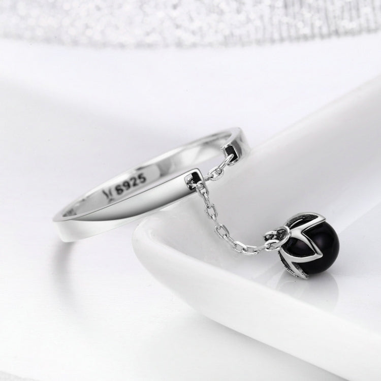 Sterling silver open ring with black pearl charm and chain detail, side view