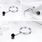 Sterling silver open ring with black pearl charm on chain, shown from multiple angles