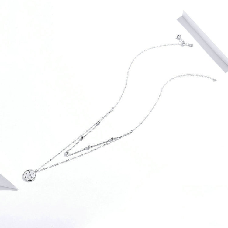 Star and round charm double-layer silver necklace with delicate chain, small sparkle accents