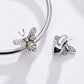 Sterling silver bee charm bead with pavé wings beside a bracelet chain
