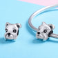 Schnauzer dog charm bead pair on a bracelet, polished silver with black enamel face