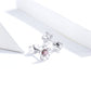Sterling silver flower stud earring with pink round zircon center, angled side view
