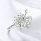 Close-up dandelion flower ring in silver with yellow center and clear CZ stones