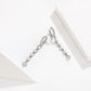 Silver-tone huggie drop earrings with stacked cz rectangles and a star end charm