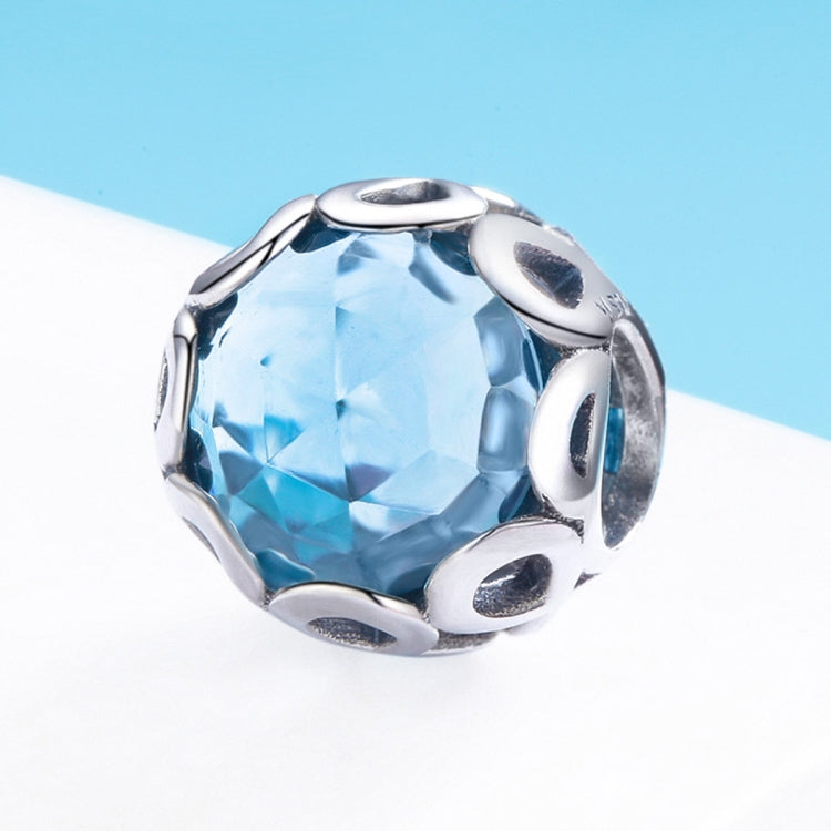 Blue faceted crystal bead with polished silver openwork side cutouts